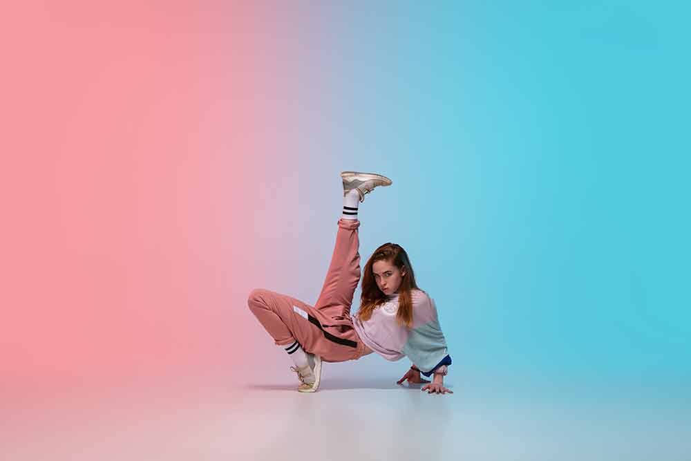girl-dancing-hip-hop-in-stylish-clothes-on-gradient-background-at-dance-hall-in-neon-light
